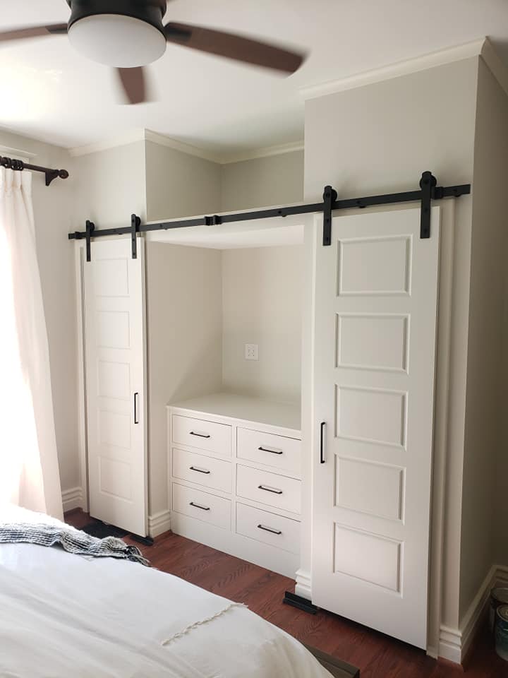 Bedroom with White barn style sliding closet doors